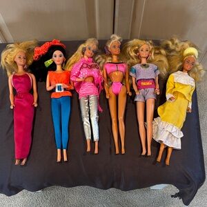 Barbie Doll Collection with Pink, Blue, Silver, and Yellow Outfits